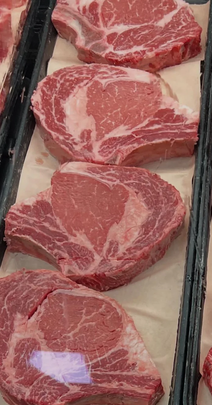 Fresh marbled steaks arranged in the meat display at Sidra